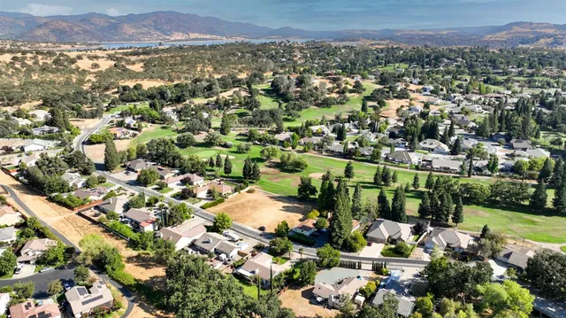 an aerial view of lake and residential houses with outdoor space