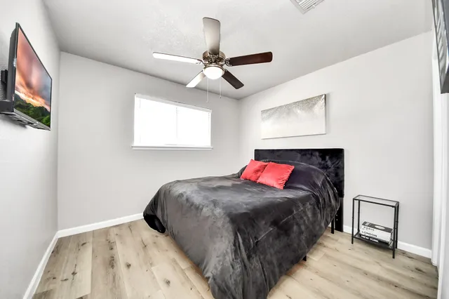 a bedroom with a bed and a flat screen tv