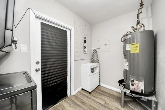 a kitchen with a refrigerator and a stove top oven