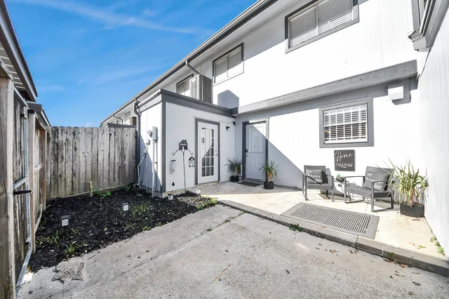 a backyard of a house with table and chairs