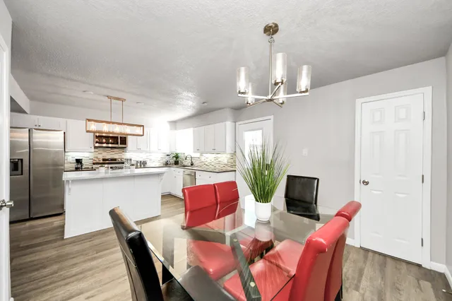 a dining room with furniture a window and wooden floor
