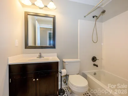 a bathroom with a toilet sink shower and mirror