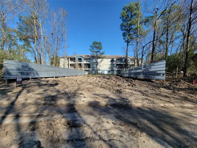 a view of a backyard with large trees