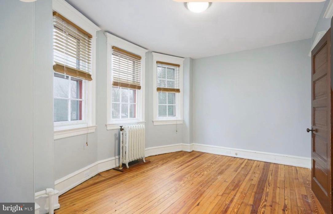 239 Kings Highway East, Unit B Haddonfield, NJ 08033 - Photo 11 of 14 an empty room with wooden floor and windows