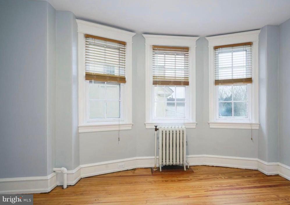 239 Kings Highway East, Unit B Haddonfield, NJ 08033 - Photo 13 of 14 an empty room with wooden floor and windows