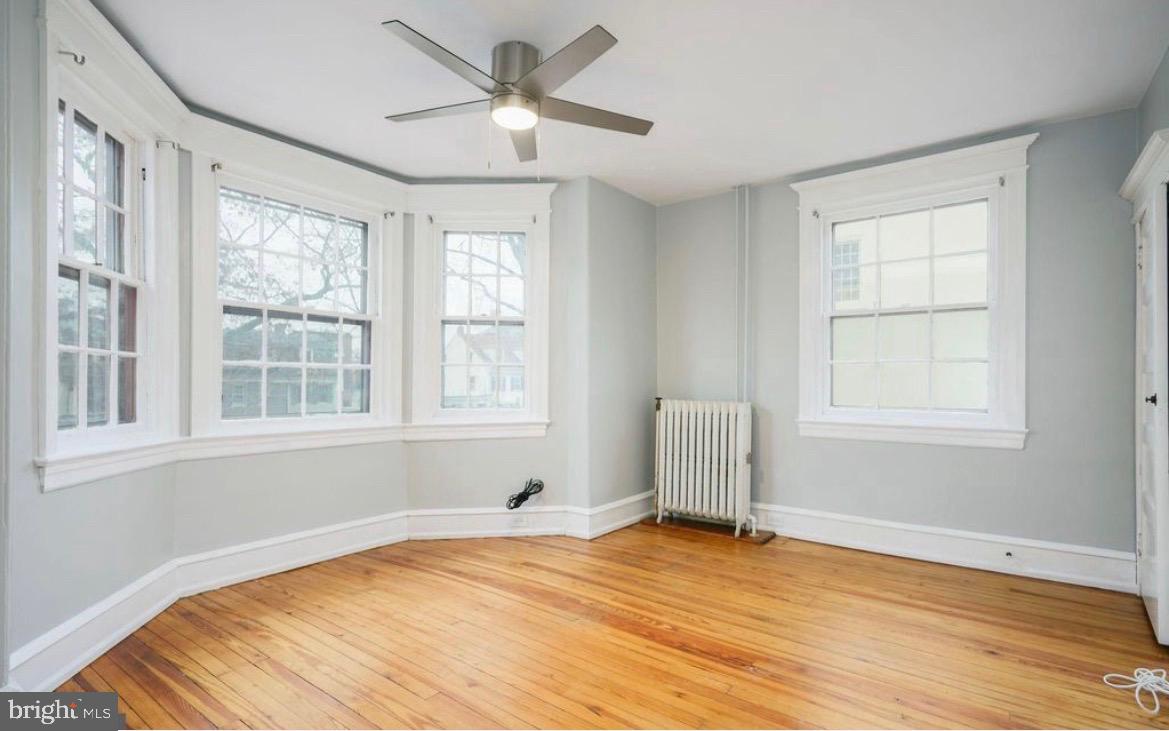 239 Kings Highway East, Unit B Haddonfield, NJ 08033 - Photo 3 of 14 a view of an empty room with a window and wooden floor