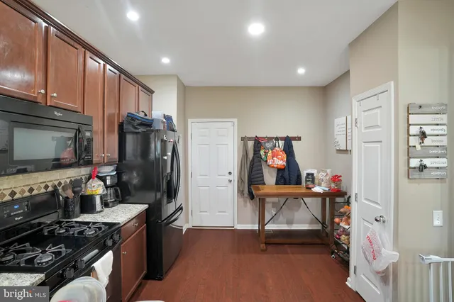 a kitchen with stainless steel appliances a stove a refrigerator and a refrigerator