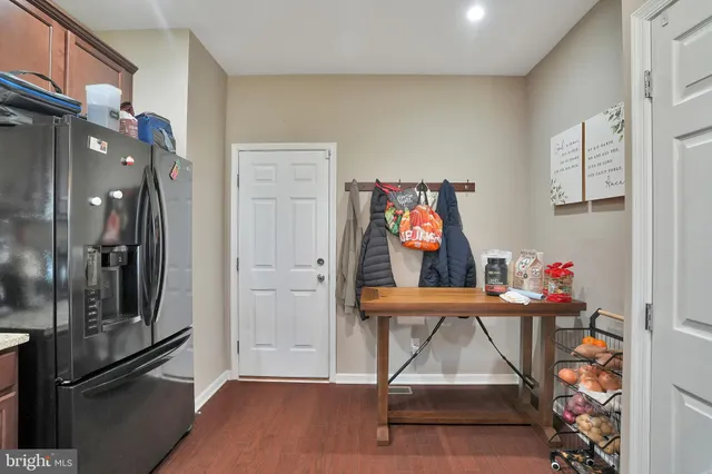a view of entryway with furniture and wooden floor