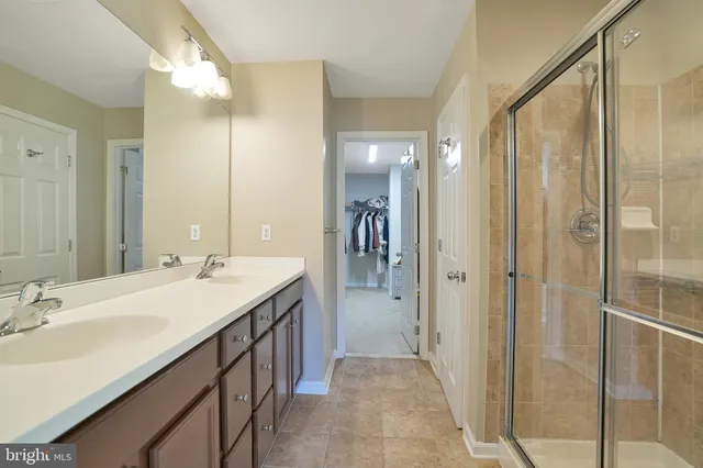 a bathroom with a double vanity sink a and mirror