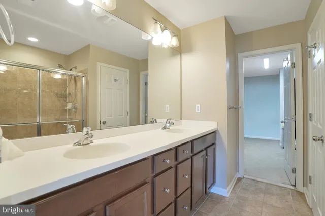 a bathroom with a sink double vanity and a mirror
