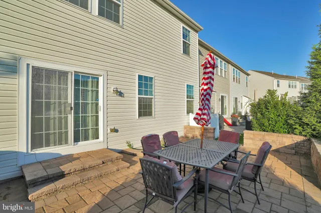 a outdoor space with a table and chairs