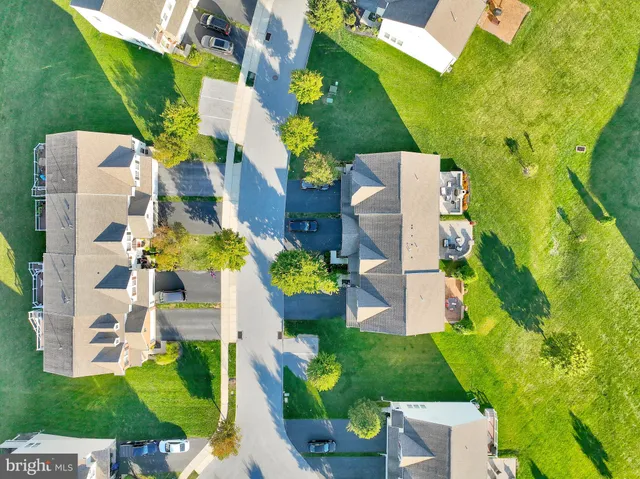 an aerial view of a house with a yard basket ball court and outdoor seating