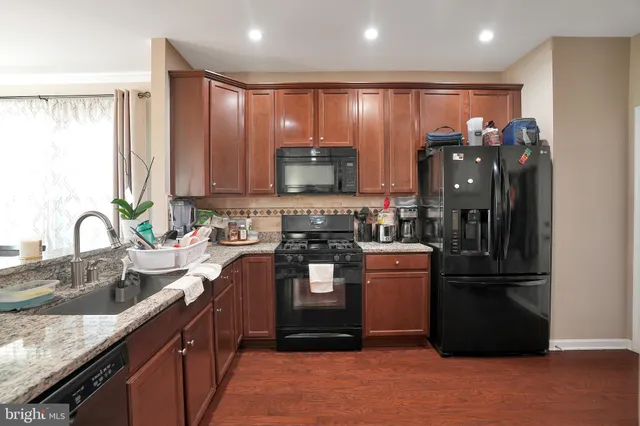a kitchen with a refrigerator and a sink