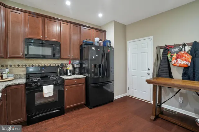 a kitchen with stainless steel appliances granite countertop a refrigerator stove and microwave