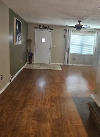 an empty room with windows and cabinet