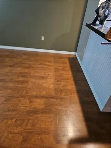 a view of a room with wooden floor