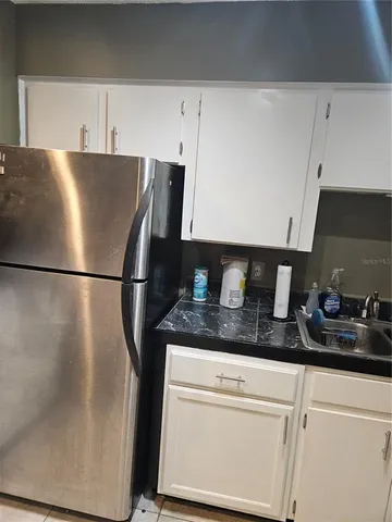 a kitchen with stainless steel appliances granite countertop a refrigerator sink and cabinets