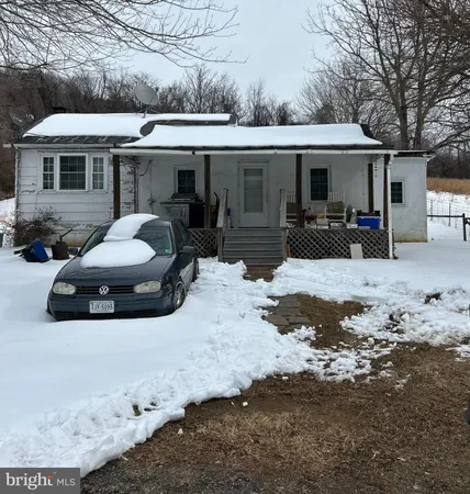 a view of a house with a yard covered in snow
