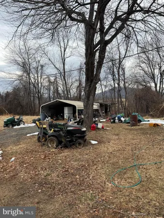 a view of backyard with table and chairs and a fire pit