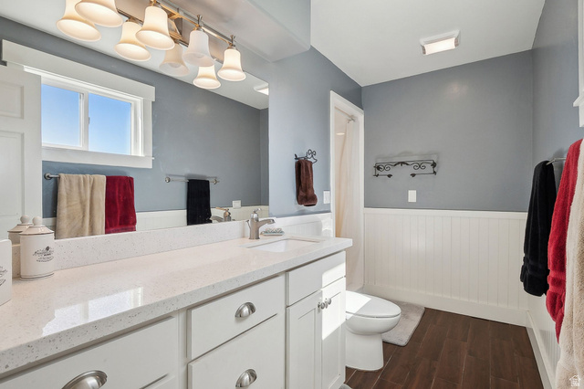 550 Pine Canyon Road Midway, UT 84049 - Photo 18 of 44 Bathroom featuring a white vanity with a light-toned countertop, wood-finish flooring, and wainscoting