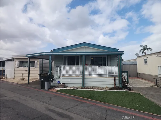 a view of house with yard and entertaining space