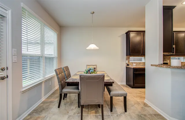 a dining room with furniture and window