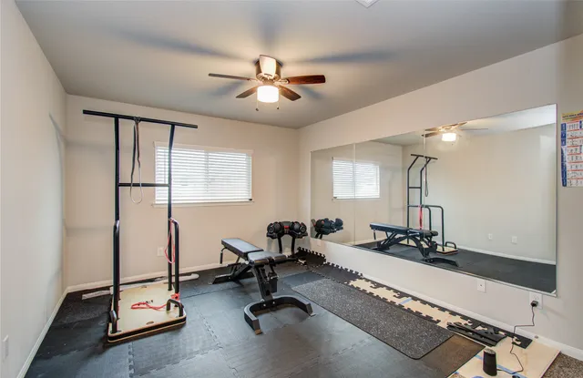 a room with gym equipment and a large window