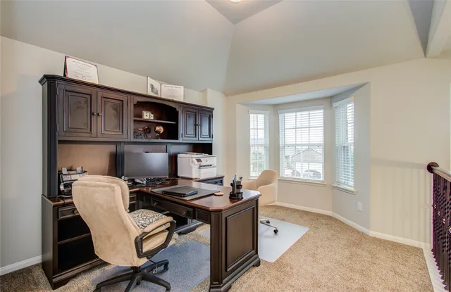 a workspace with a computer on a desk and chair