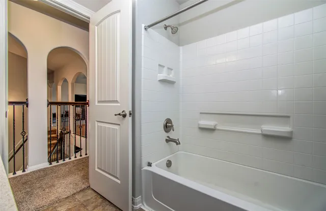 a bathroom with a tub a sink and a shower