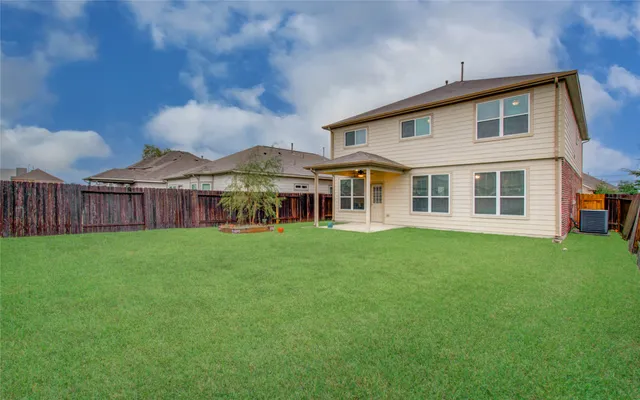 a view of a house with a yard and sitting area