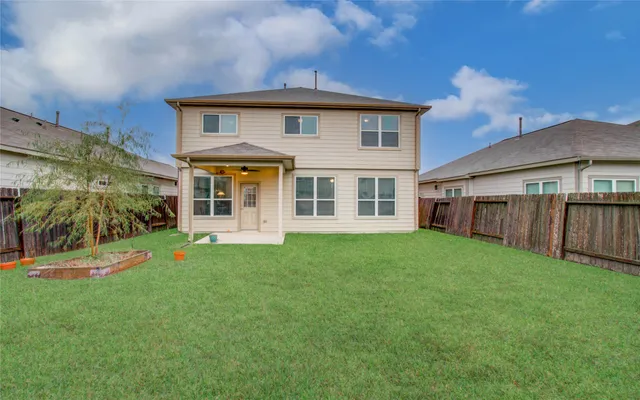 a view of a house with a yard and deck