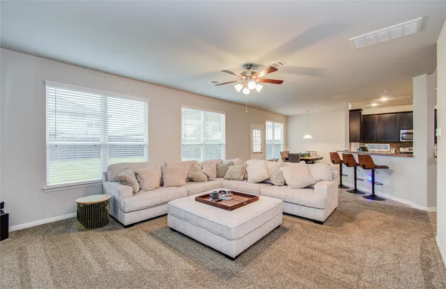 a living room with furniture ceiling and a flat screen tv