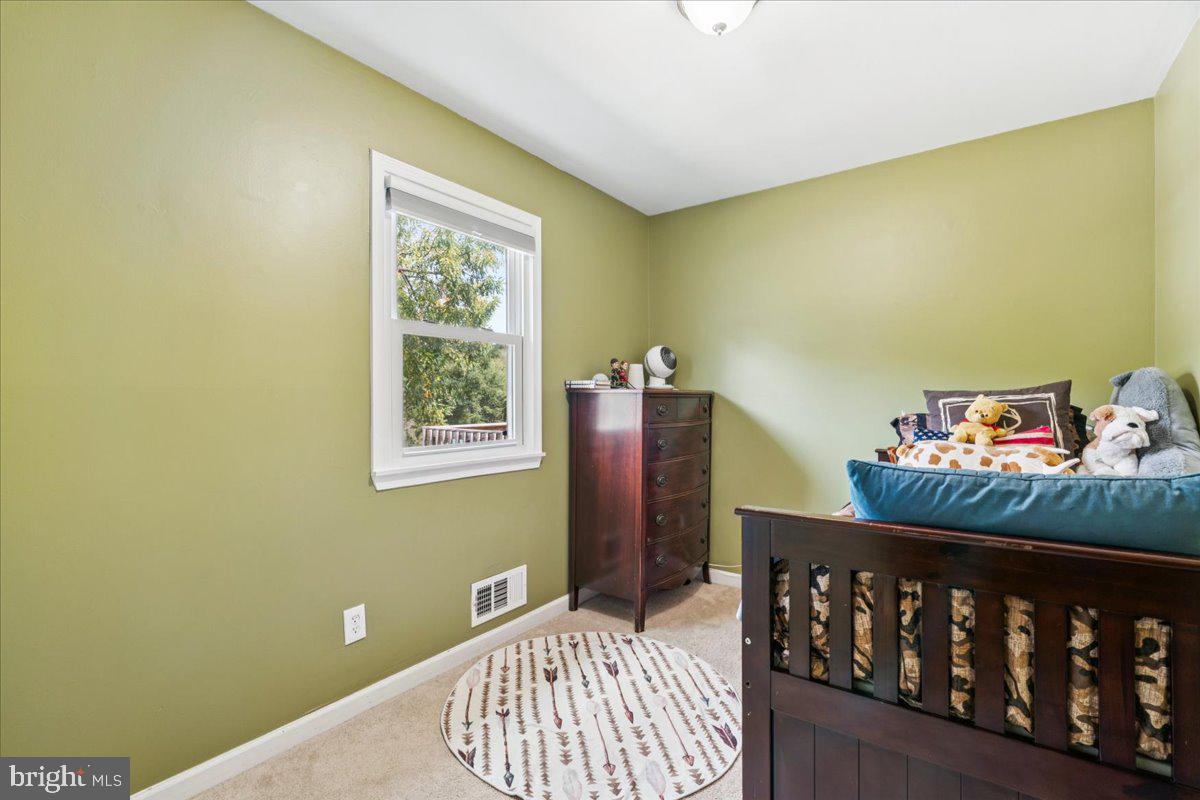 7830 Fingerboard Road Frederick, MD 21704 - Photo 17 of 39 a bedroom with a bed and wooden floor