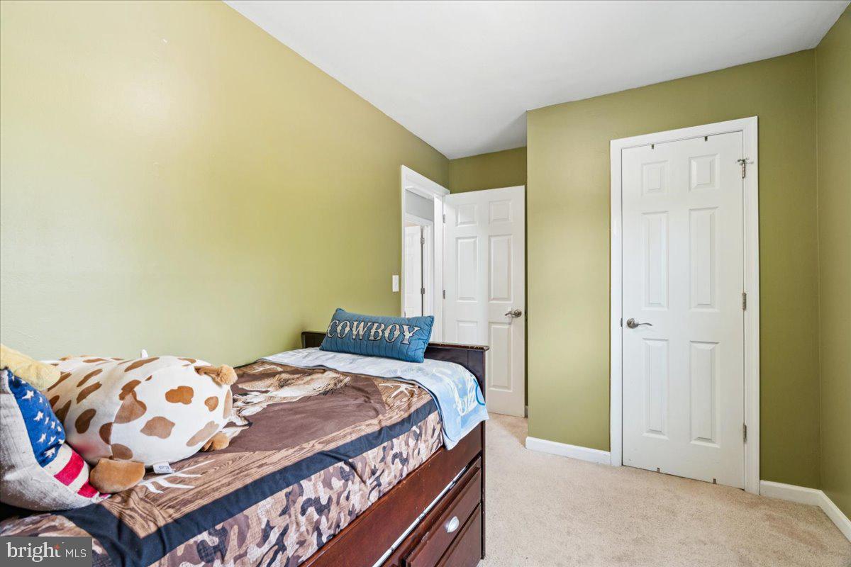 7830 Fingerboard Road Frederick, MD 21704 - Photo 18 of 39 a bedroom with a bed and a painting on the wall