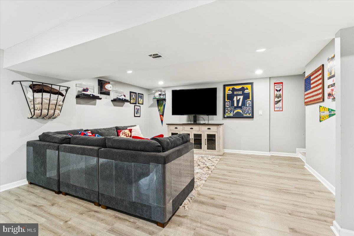 7830 Fingerboard Road Frederick, MD 21704 - Photo 20 of 39 a living room with furniture and a flat screen tv