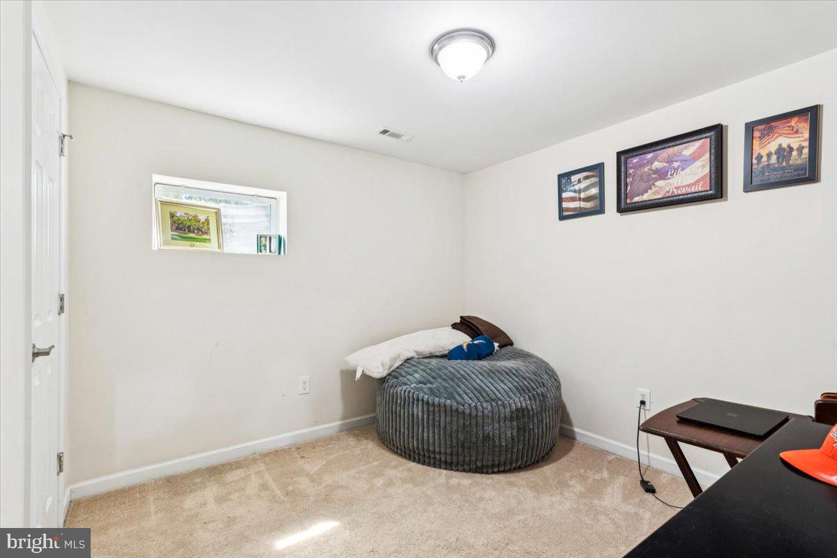7830 Fingerboard Road Frederick, MD 21704 - Photo 22 of 39 a room with a rug and a chair