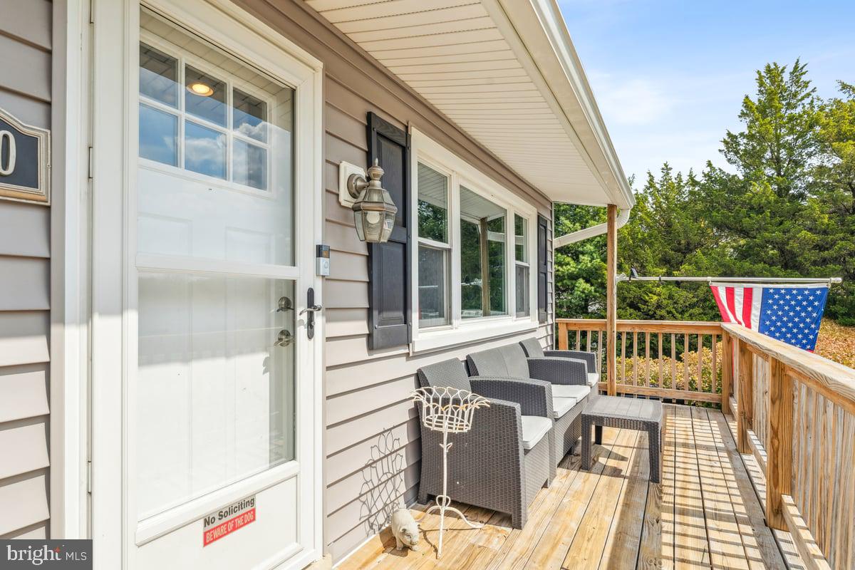 7830 Fingerboard Road Frederick, MD 21704 - Photo 3 of 39 a balcony with furniture and wooden floor