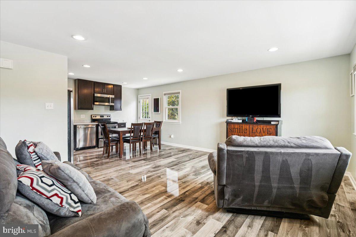 7830 Fingerboard Road Frederick, MD 21704 - Photo 5 of 39 a living room with furniture and a flat screen tv