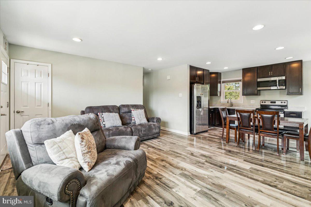 7830 Fingerboard Road Frederick, MD 21704 - Photo 6 of 39 a living room with furniture and a flat screen tv