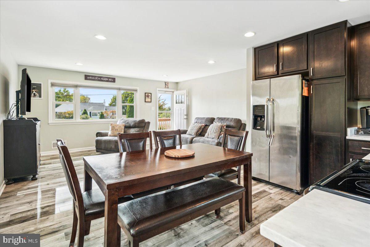 7830 Fingerboard Road Frederick, MD 21704 - Photo 9 of 39 a view of a dining room with furniture a rug and wooden floor