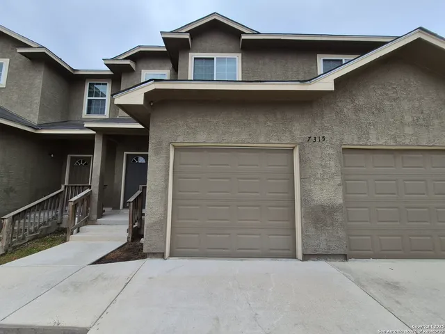 a view of house with garage
