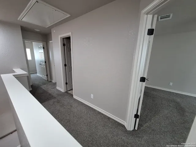 a view of a hallway view with staircase