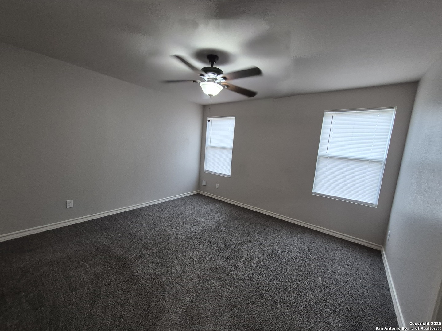 7315 Colina Way, Unit 103 Converse, TX 78109 - Photo 14 of 32 an empty room with a window and a fan