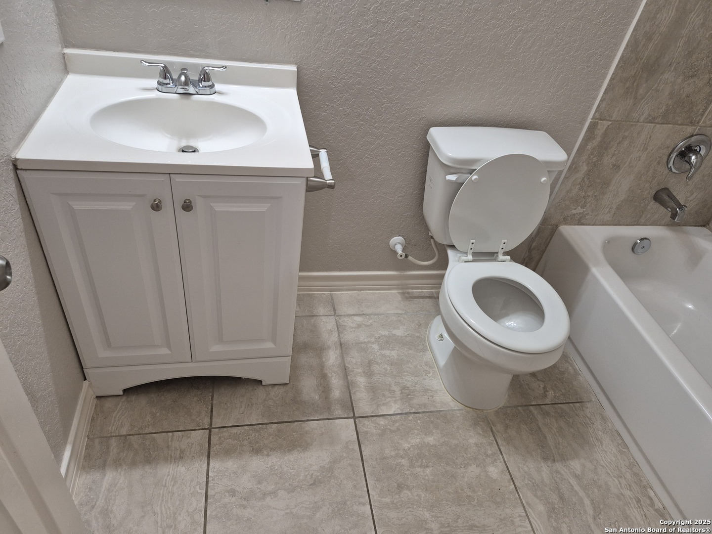 7315 Colina Way, Unit 103 Converse, TX 78109 - Photo 29 of 32 a bathroom with a toilet a sink and mirror