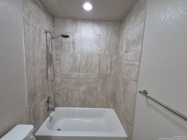 a bathroom with a bath tub and a shower