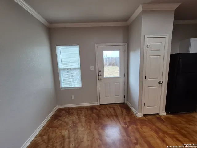 an empty room with closet and windows