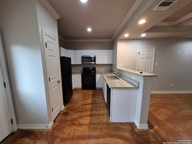 a kitchen with refrigerator and microwave