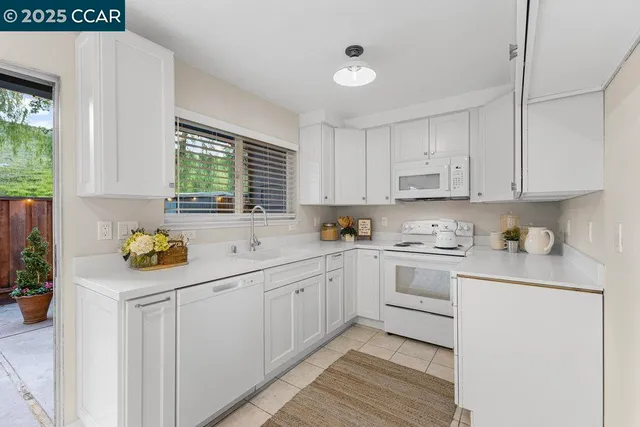 a kitchen with a sink window and cabinets