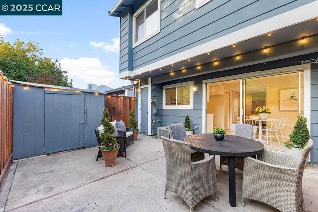 a view of a patio with table and chairs and potted plants