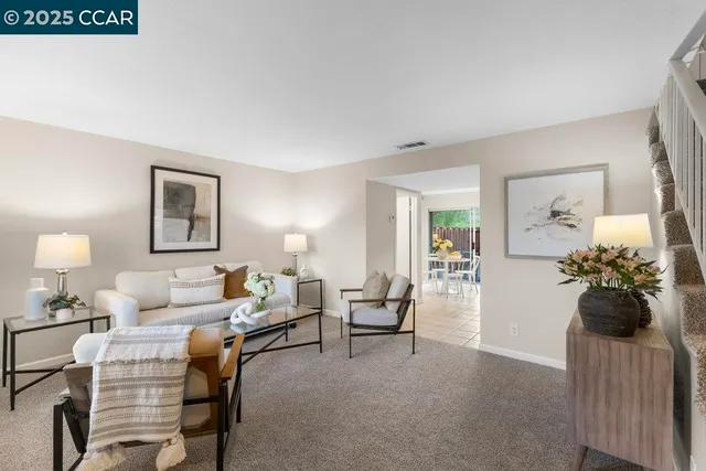 a living room with furniture and flowers